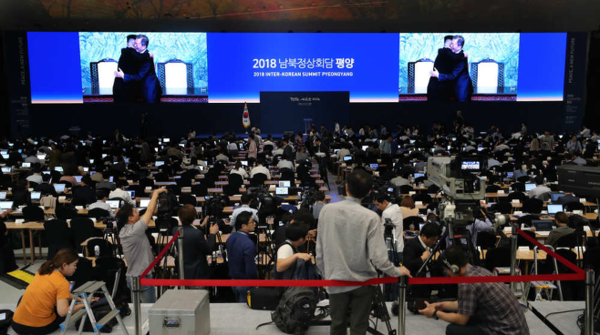 8월17일 서울 동대문디자인플라자에 마련된 남북정상회담 메인 프레스센터에 문재인 대통령과 김정은 국무위원장의 첫 만남 사진이 영상으로 소개되고 있다. (연합뉴스)